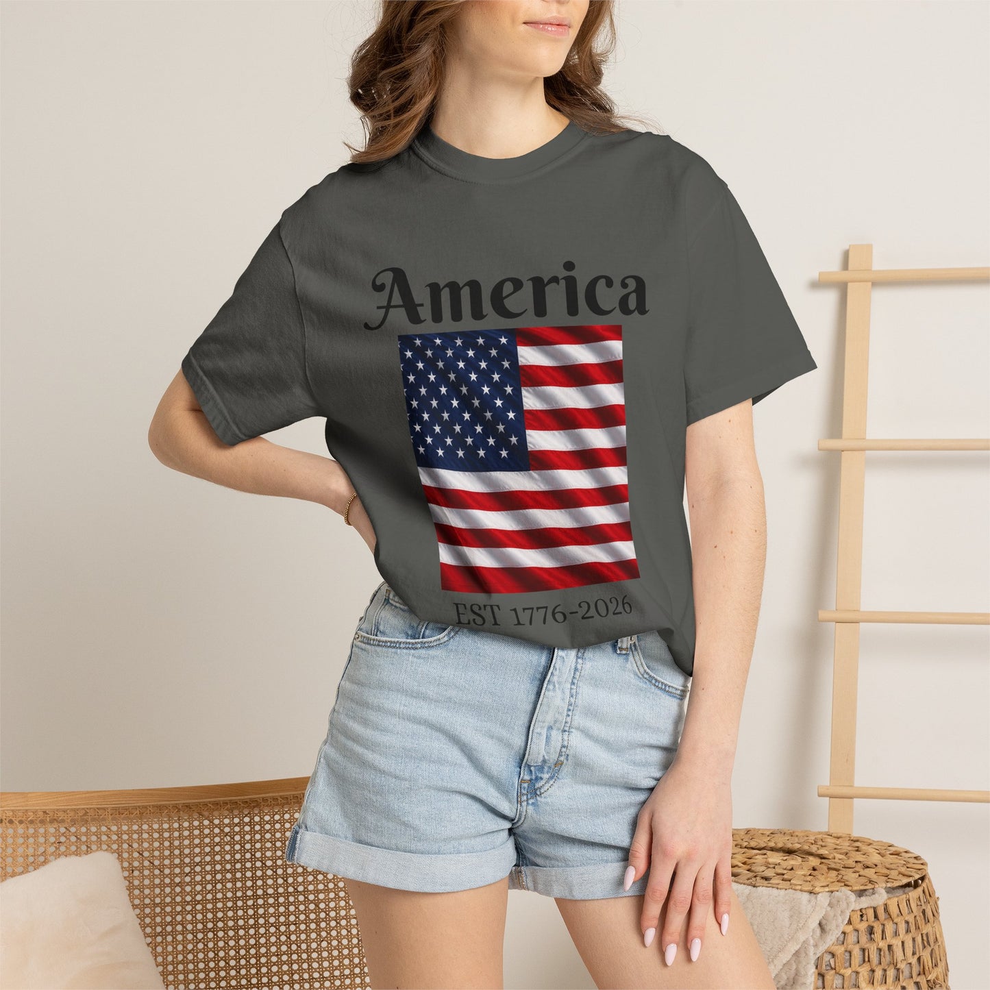 Dark gray T-shirt with America script, U.S. flag graphic, and EST 1776-2026 text