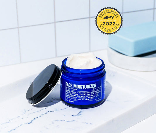 Hydrating face moisturizer jar, blue plastic with open black lid and cream product