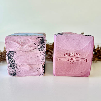 Purple speckled goat milk soap bars, one showing FARMHOUSE LATTER stamp