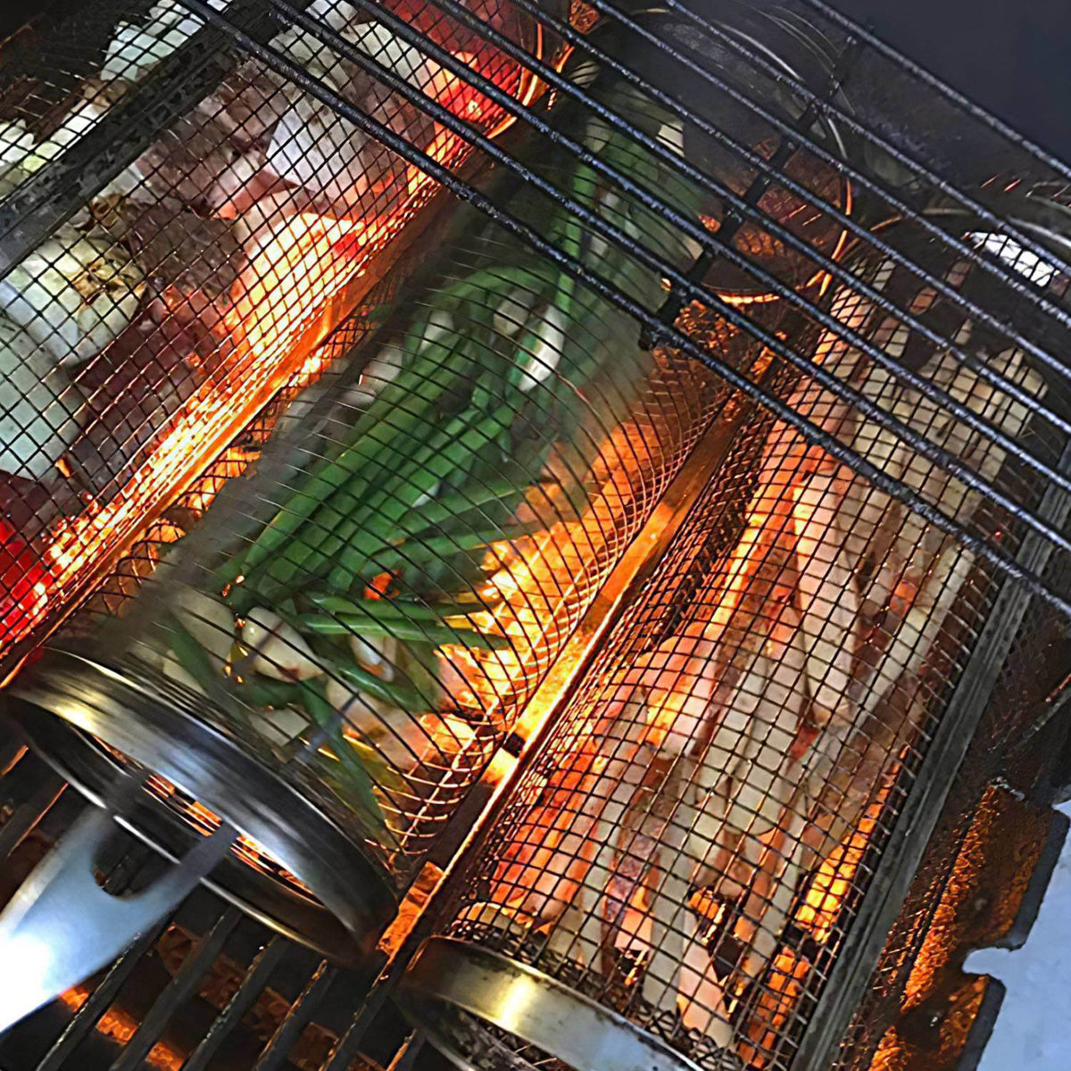Stainless steel mesh grill basket over open flames