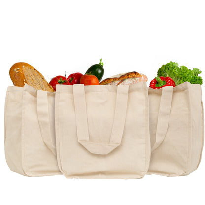 Canvas grocery tote bags, beige with side pockets holding bread and vegetables