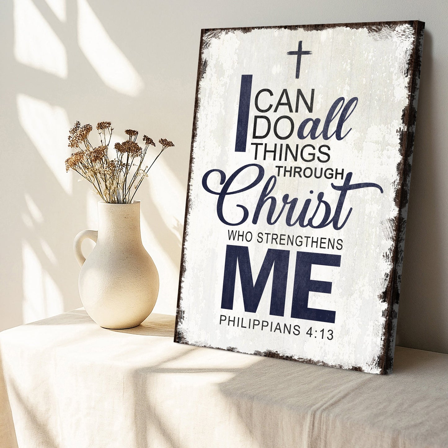 Canvas sign on a tabletop with cross and “I can do all things through Christ” text