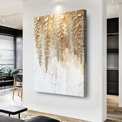 Gold wisteria relief wall art with textured leaf design and white background on hanging canvas.
