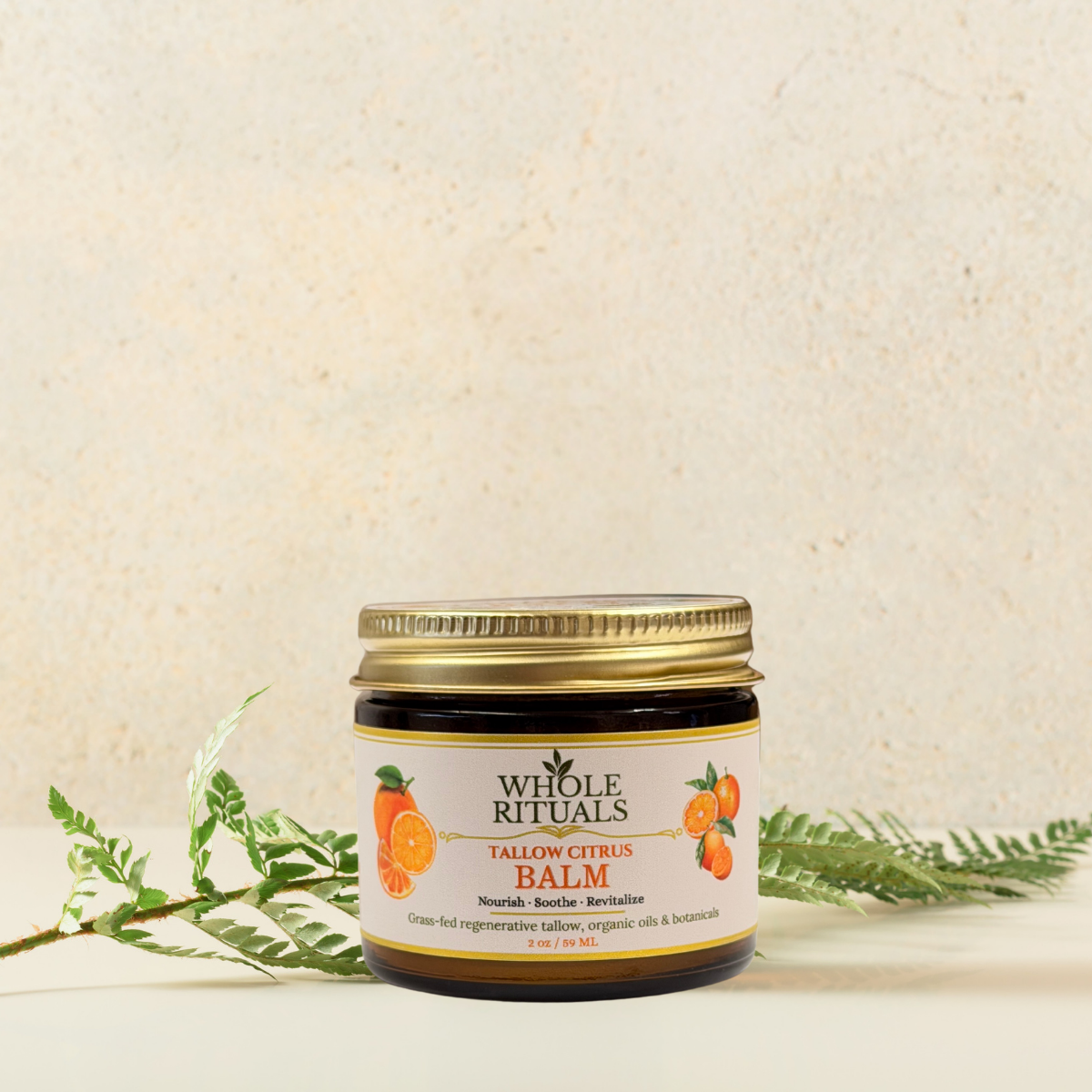 Tallow citrus balm jar with gold lid, Whole Rituals citrus label, on light stone background