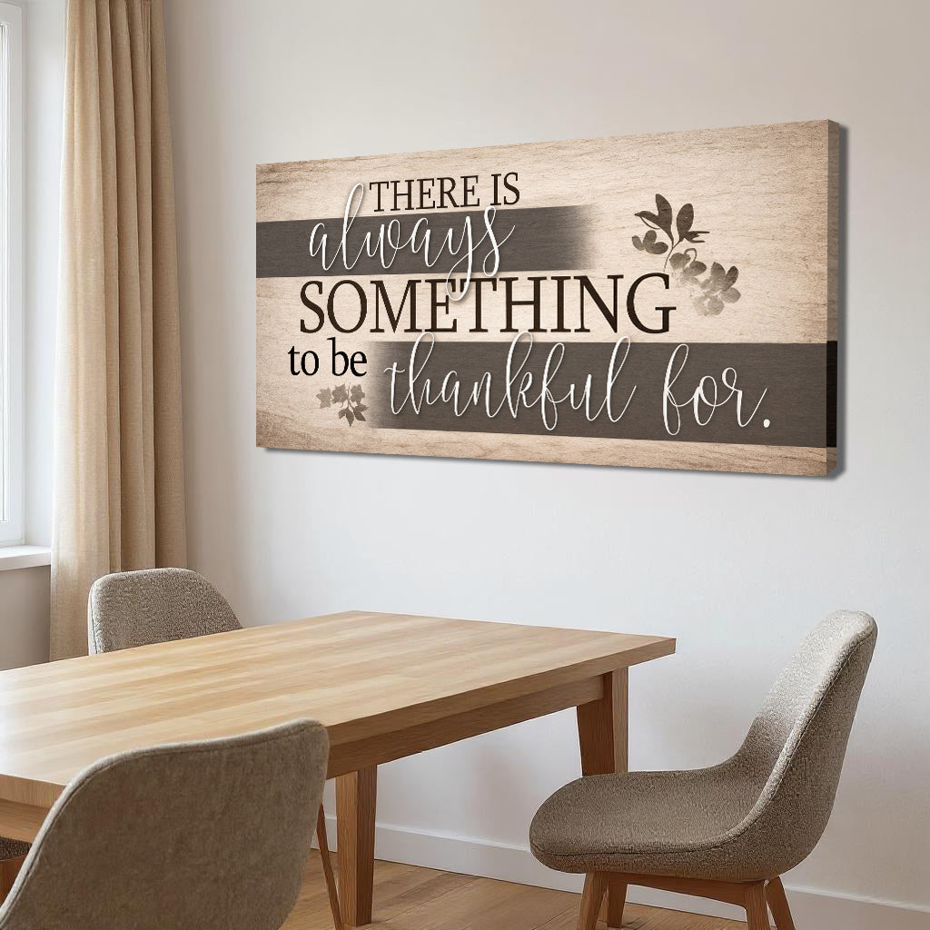 Woodgrain wall sign with gray stripe and the quote “There is always something to be thankful for.”