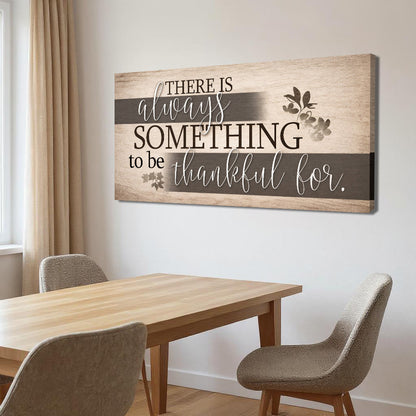Woodgrain wall sign with gray stripe and the quote “There is always something to be thankful for.”