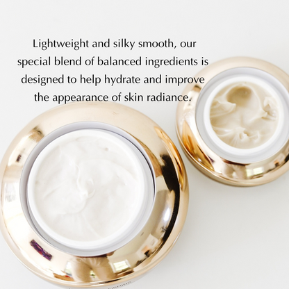 Under eye cream jars with white cream in open gold-rimmed lids.
