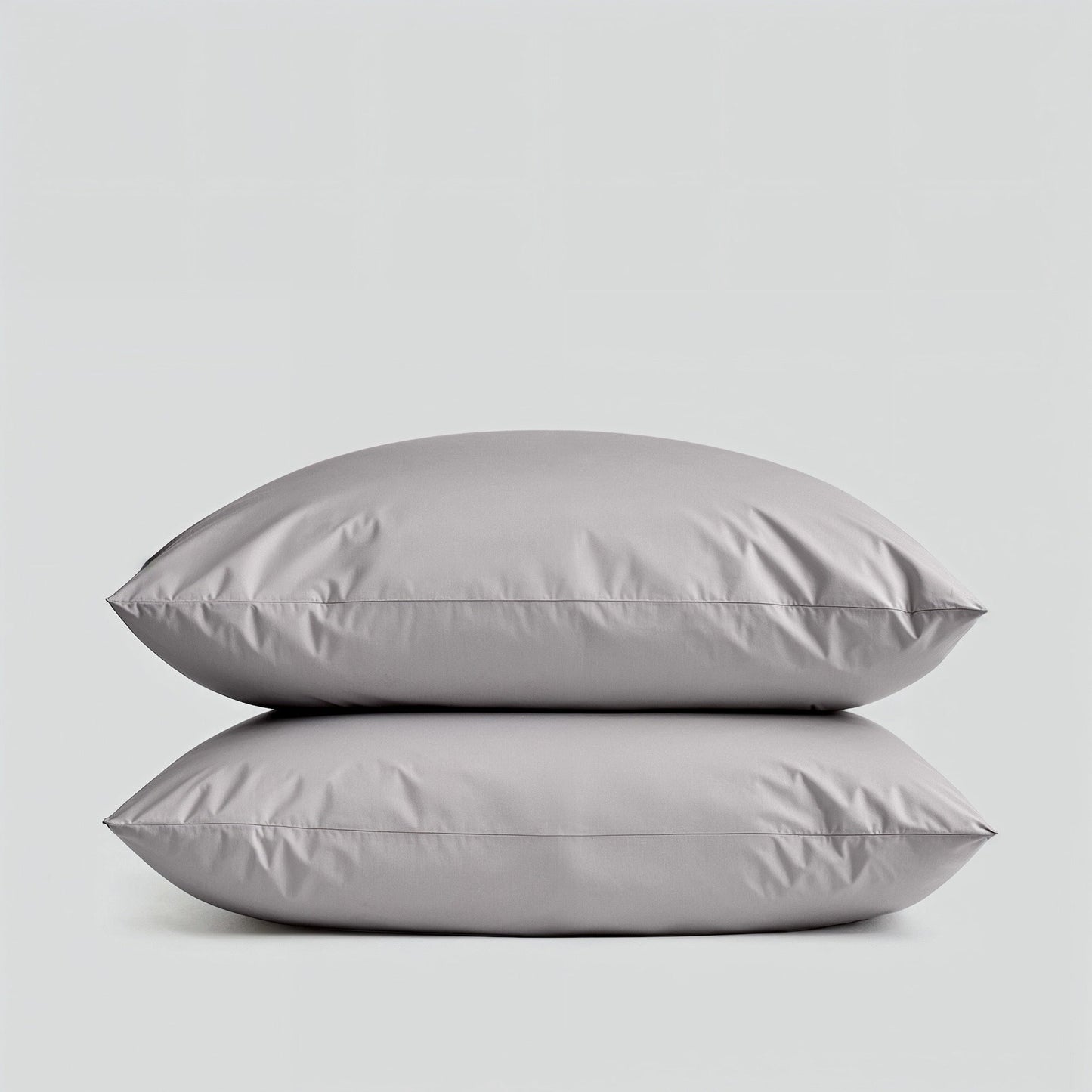 Sateen bedding bundle with two gray pillows stacked, showing smooth surface