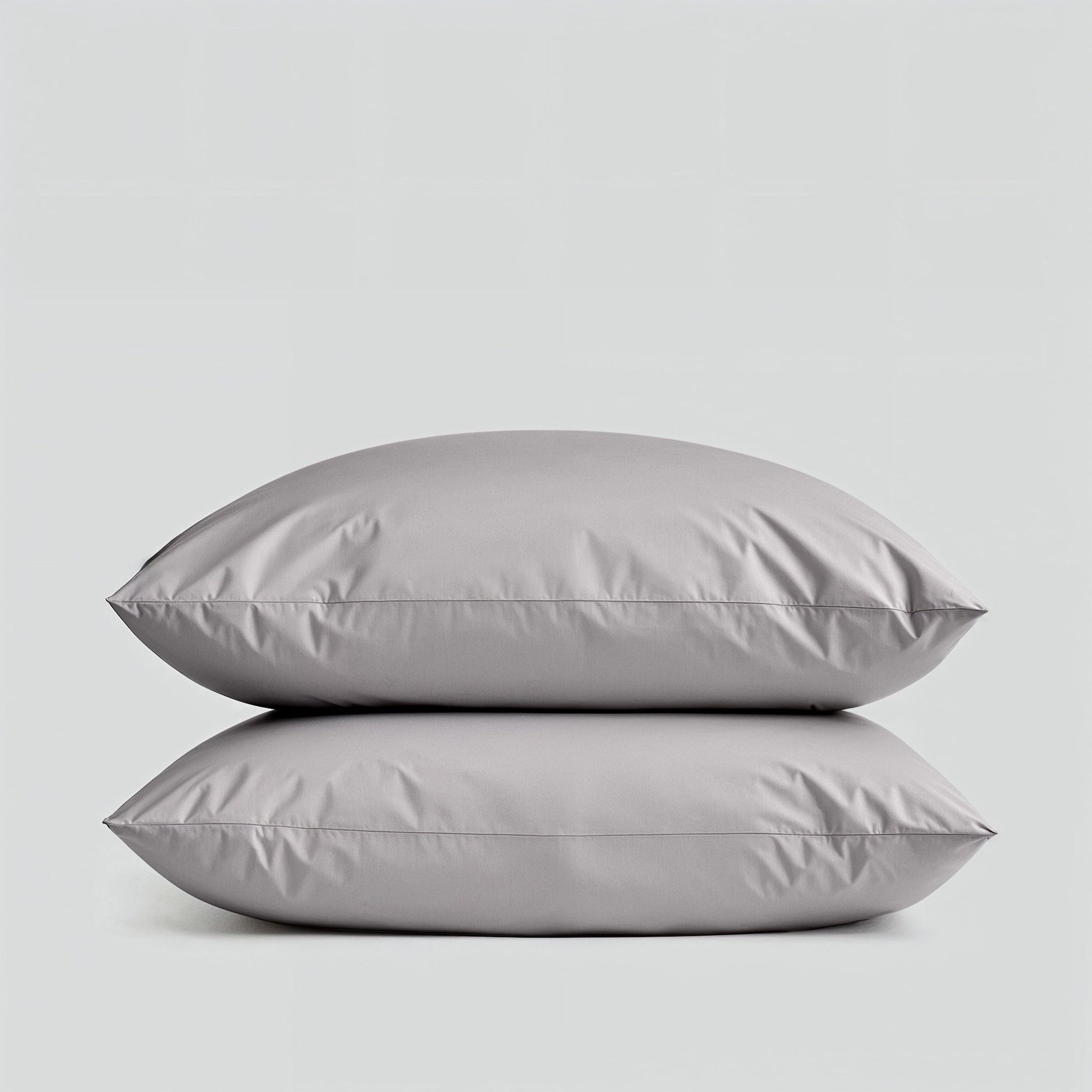 Sateen bedding bundle with two gray pillows stacked, showing smooth surface