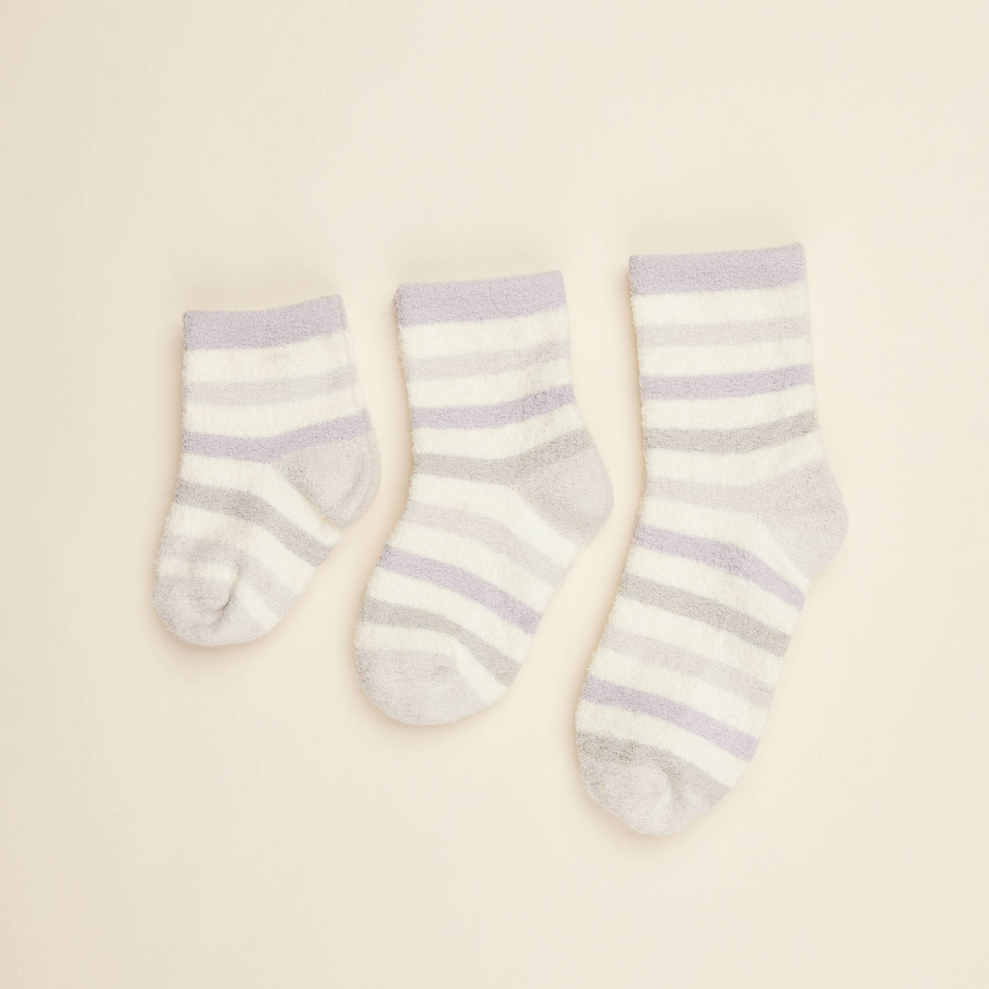 Three cream crew socks with lilac horizontal stripes and small toe bear print