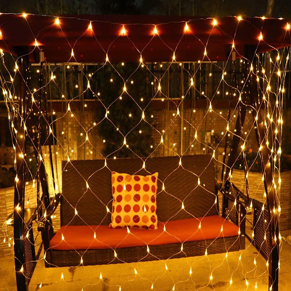 Net mesh solar fairy lights with warm white glow over outdoor seating