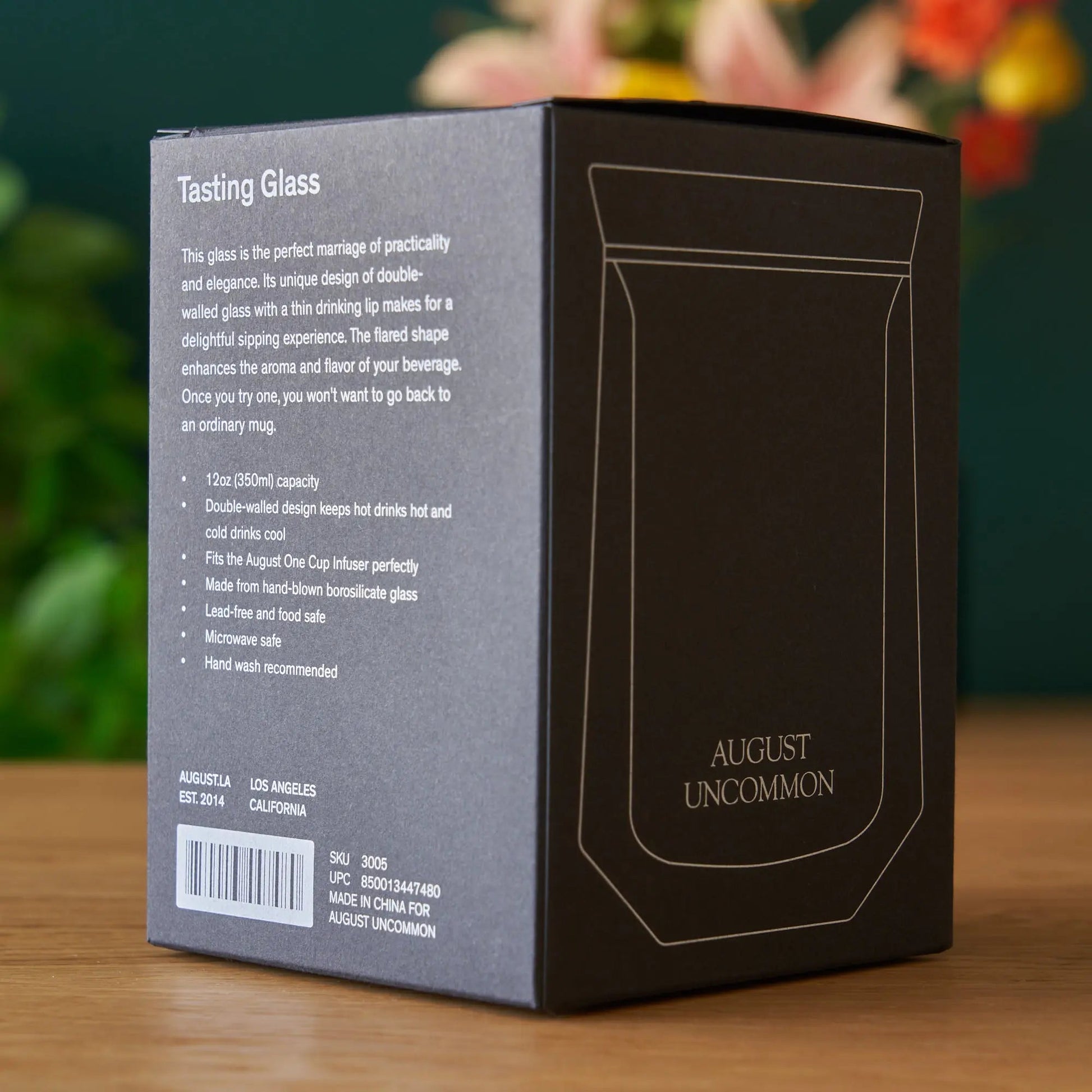 AUGUST UNCOMMON tasting glass box with printed description and label text on side