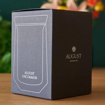 AUGUST UNCOMMON tasting glass packaging box, dark front panel with logo