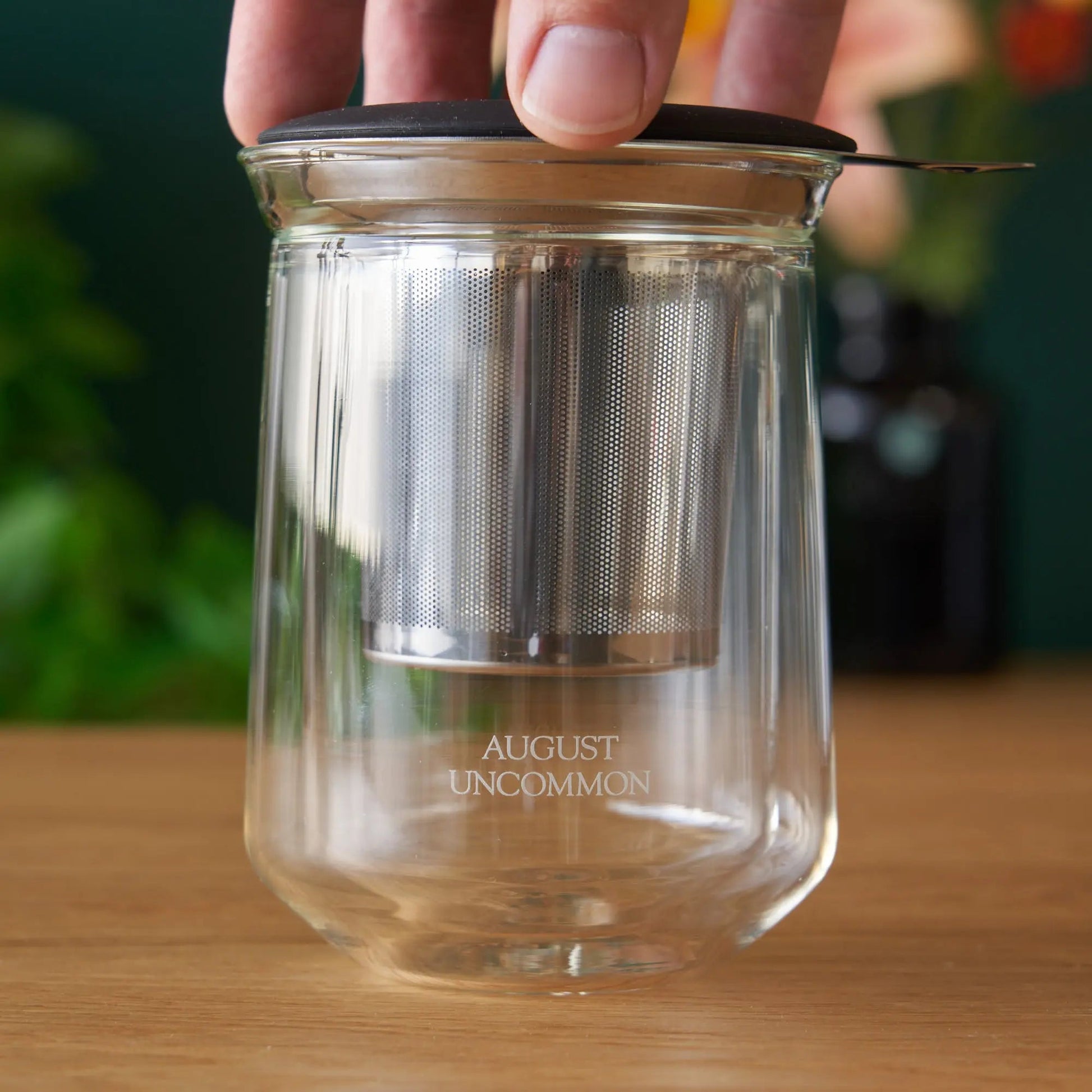 Clear tasting glass with perforated metal insert; AUGUST UNCOMMON etched on base