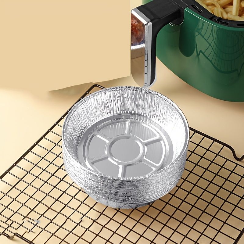 Round aluminum foil liner pan on a wire rack, showing the circular center detail