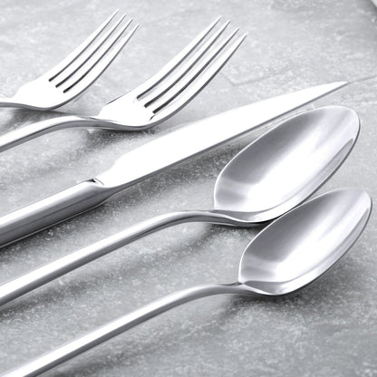 Close-up of silver forks and spoons with reflective polished bowls