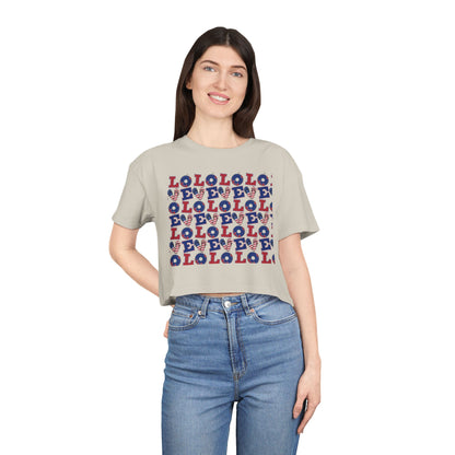 Light beige crop graphic tee with multicolor LOLO pattern front, crew neck, short sleeves
