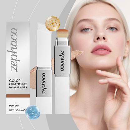 Color-changing foundation stick with brush tip near model face, plus boxed tube