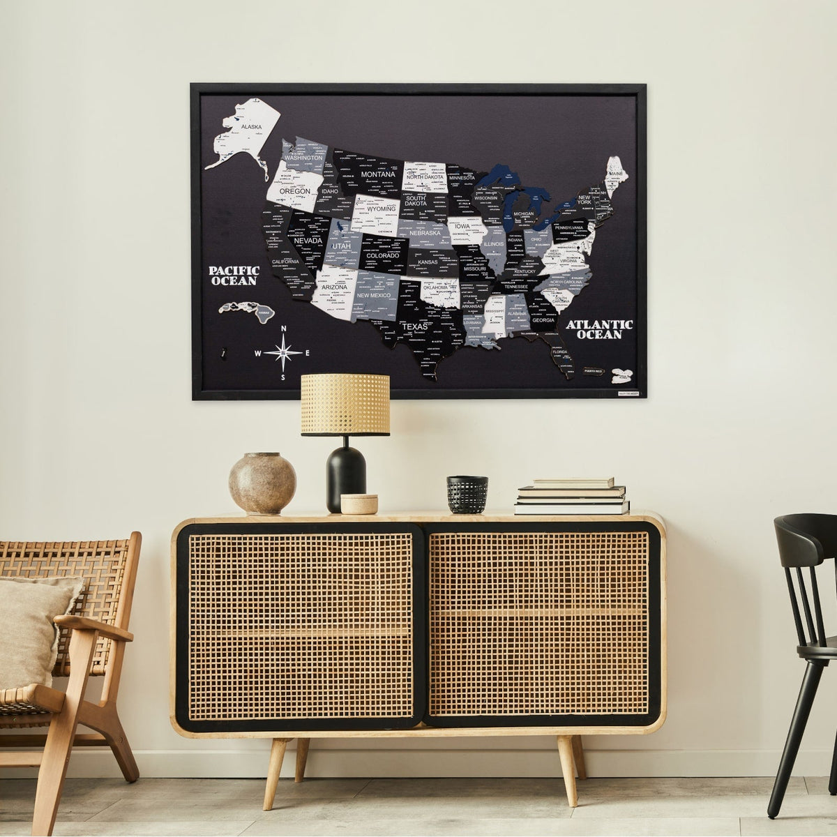 Black USA map board in dark frame with layered state label blocks and coastline outlines