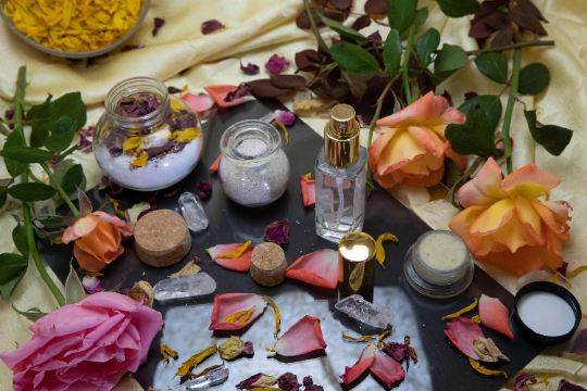 Pampering spa bundle flat lay with jars, bottles, and scattered flower petals