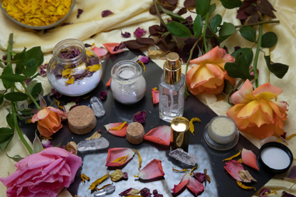 Pampering spa bundle flat lay with jars, bottles, and scattered flower petals