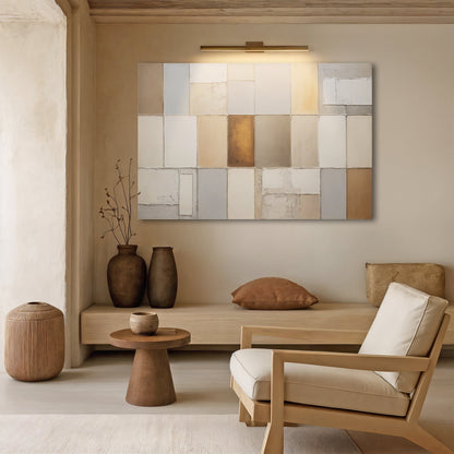 Geometric patchwork wall art with cream, gray, and warm gold square tile pattern