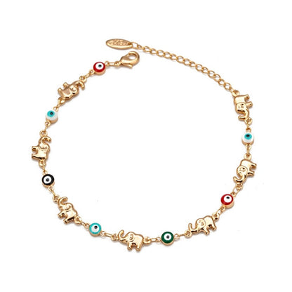 Gold-tone elephant charm bracelet with evil-eye beads and red accent charms
