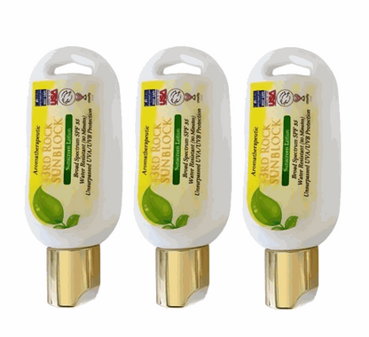 Three mini sunscreen lotion tubes, white and gold with green leaf label