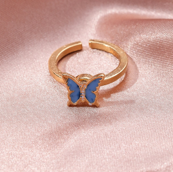 Butterfly fidget spinner ring with gold band and blue butterfly enamel