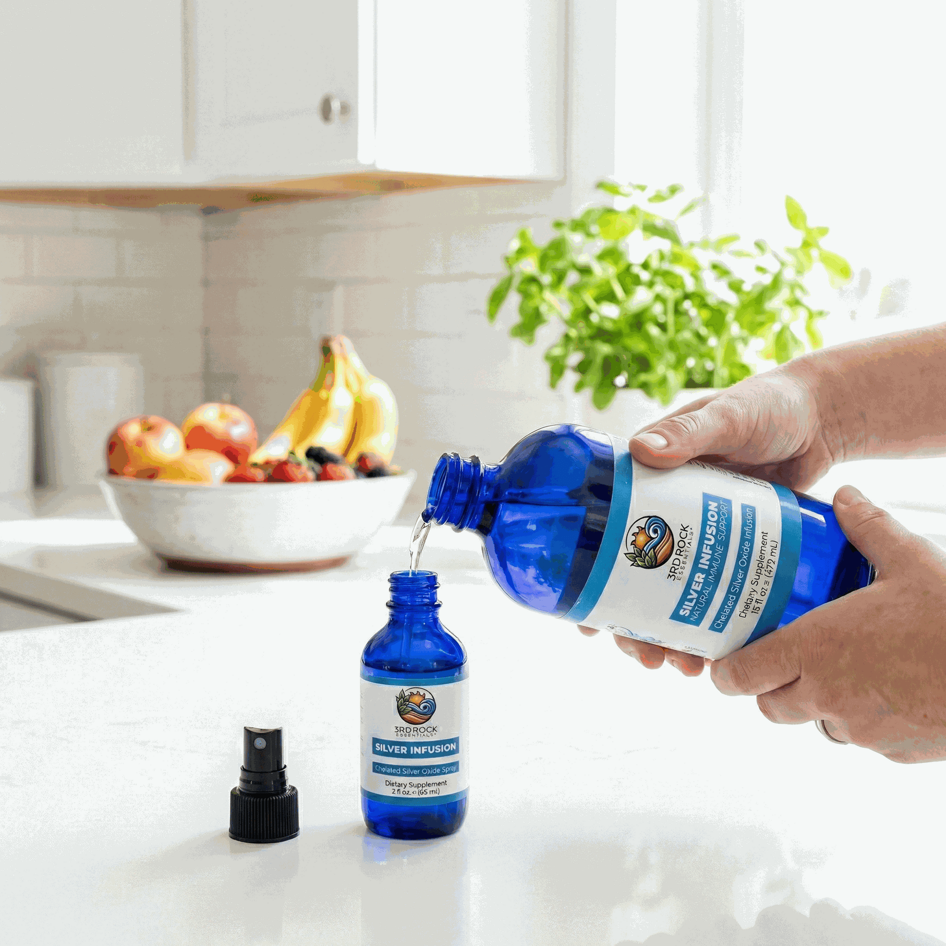 Silver infusion supplement bottle being held next to a small dropper bottle