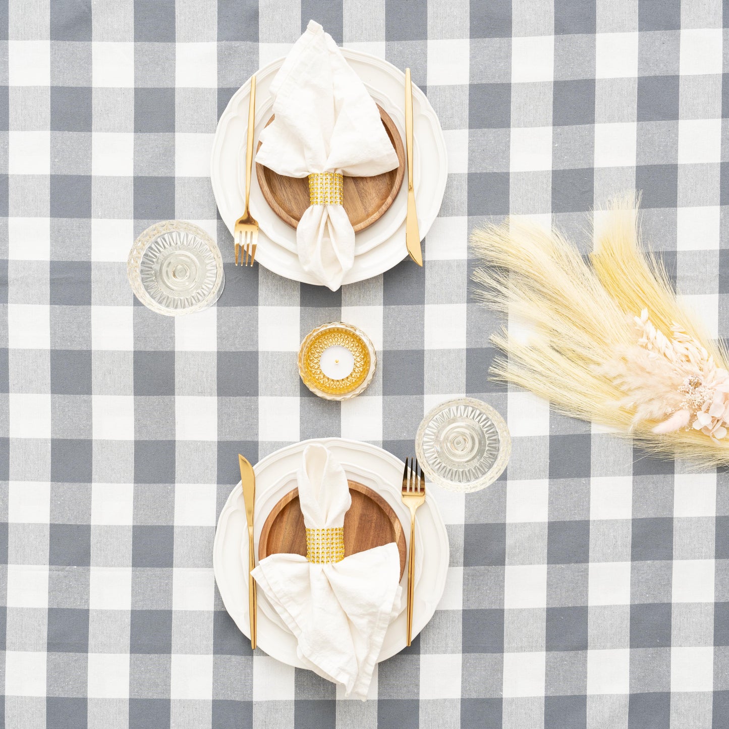 Gray and white plaid tablecloth with folded napkins on top