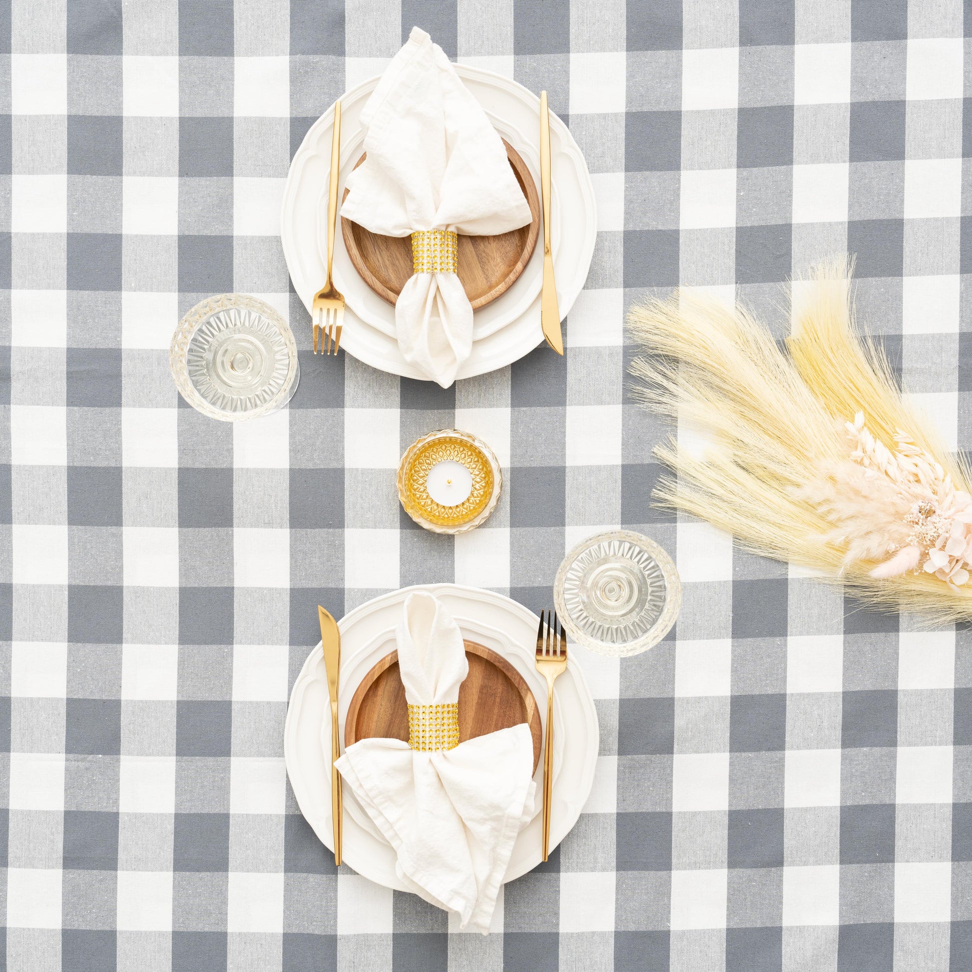 Gray and white plaid tablecloth with folded napkins on top