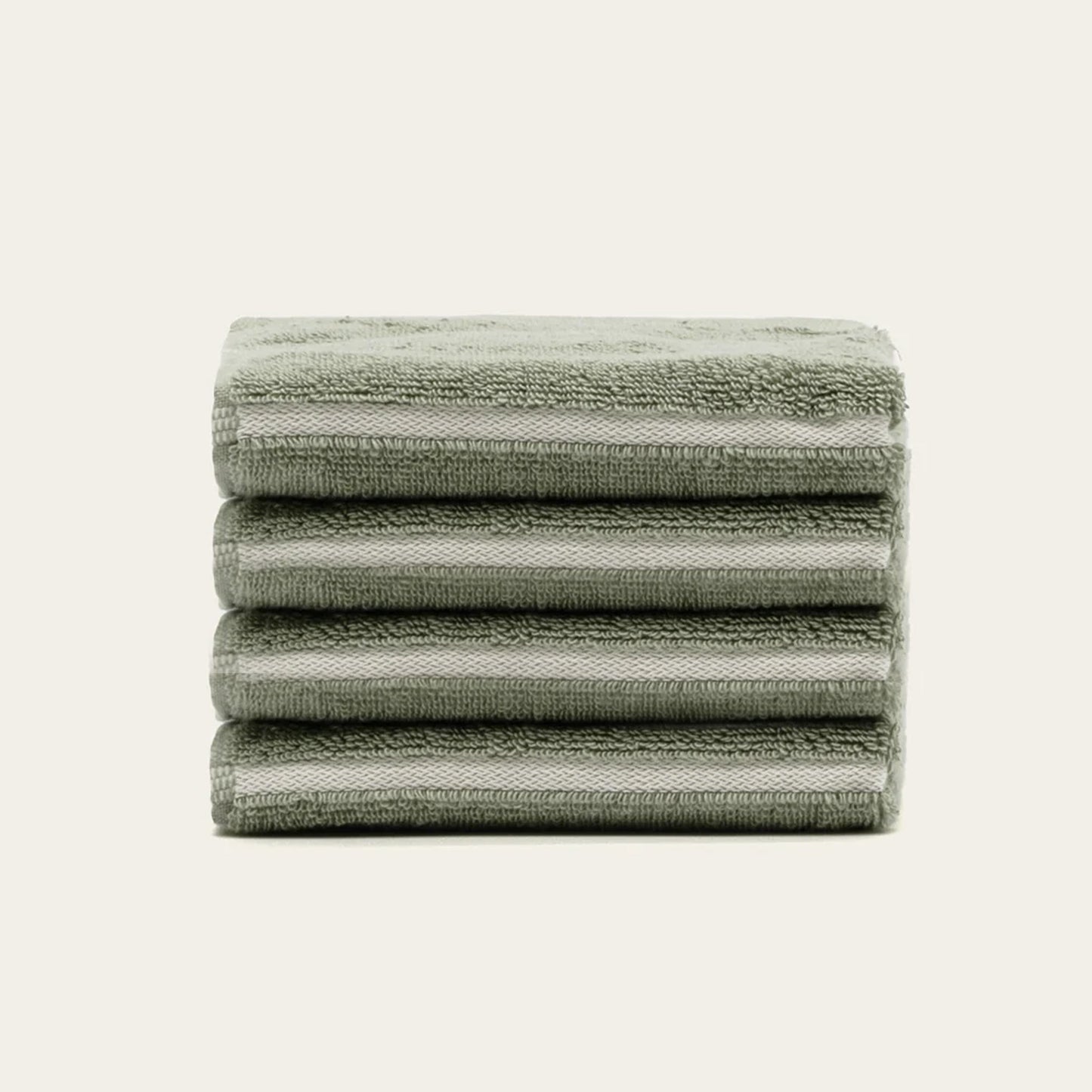 Sage green cotton towels, folded stack with horizontal stripes