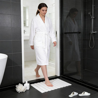Rectangular dark gray diatomite bath mat with ribbed, non-slip surface.