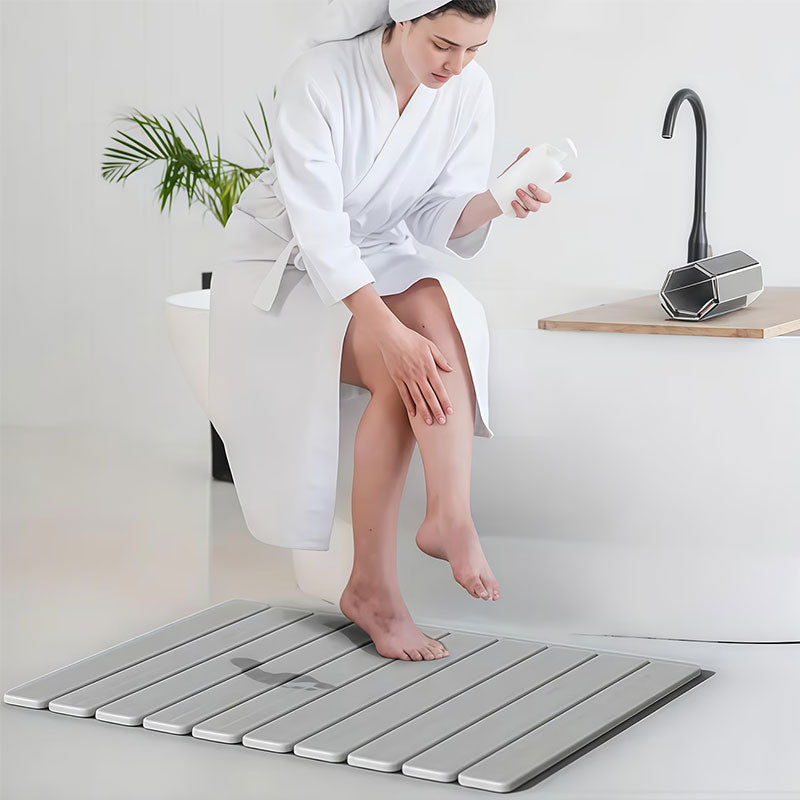 Rectangular dark gray diatomite bath mat with ribbed non-slip texture.