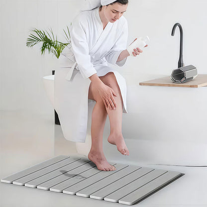 Rectangular dark gray diatomite bath mat with ribbed non-slip texture.