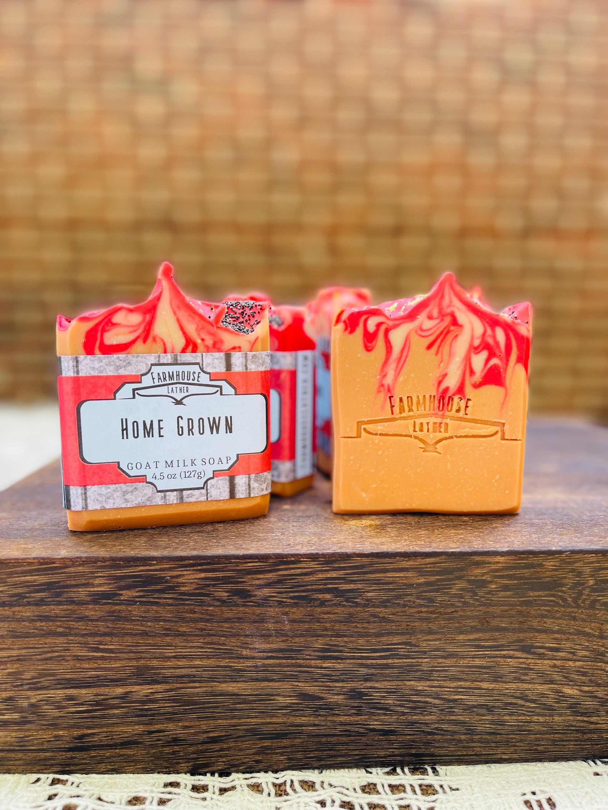 Two wrapped soap bars in boxes, one red and one yellow