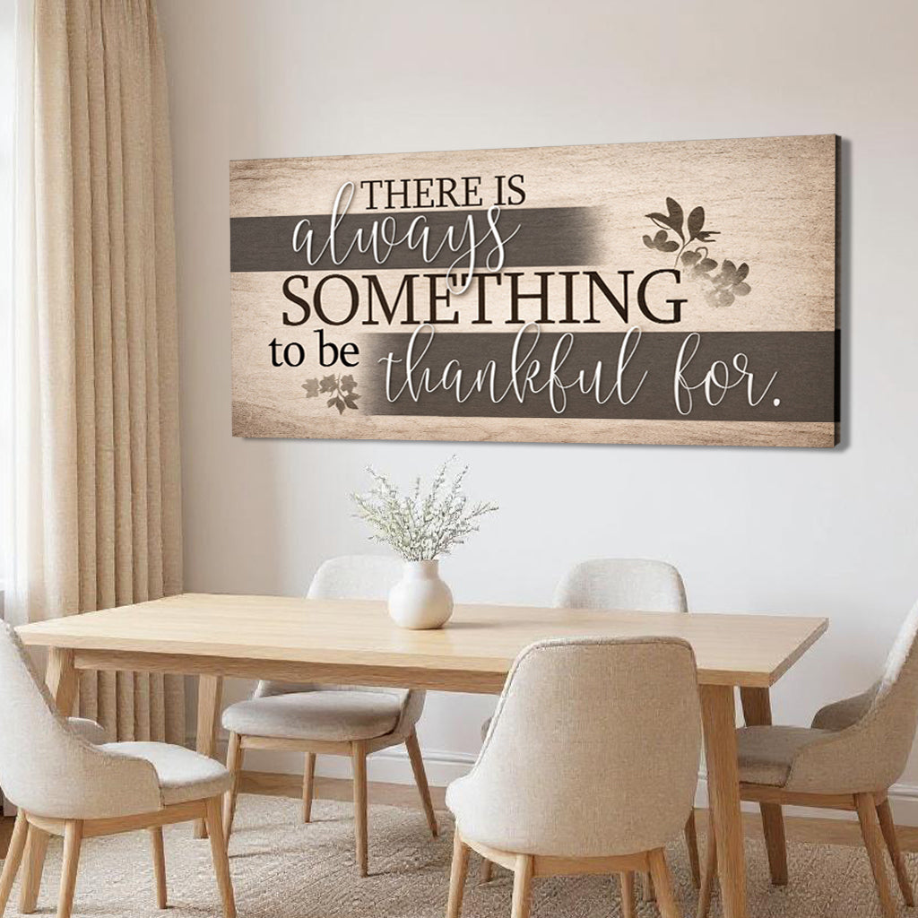 Rectangular wall sign showing “There is always something to be thankful for.” with floral accents.