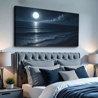 Coastal night seascape canvas wall art with moonlit shoreline above sofa