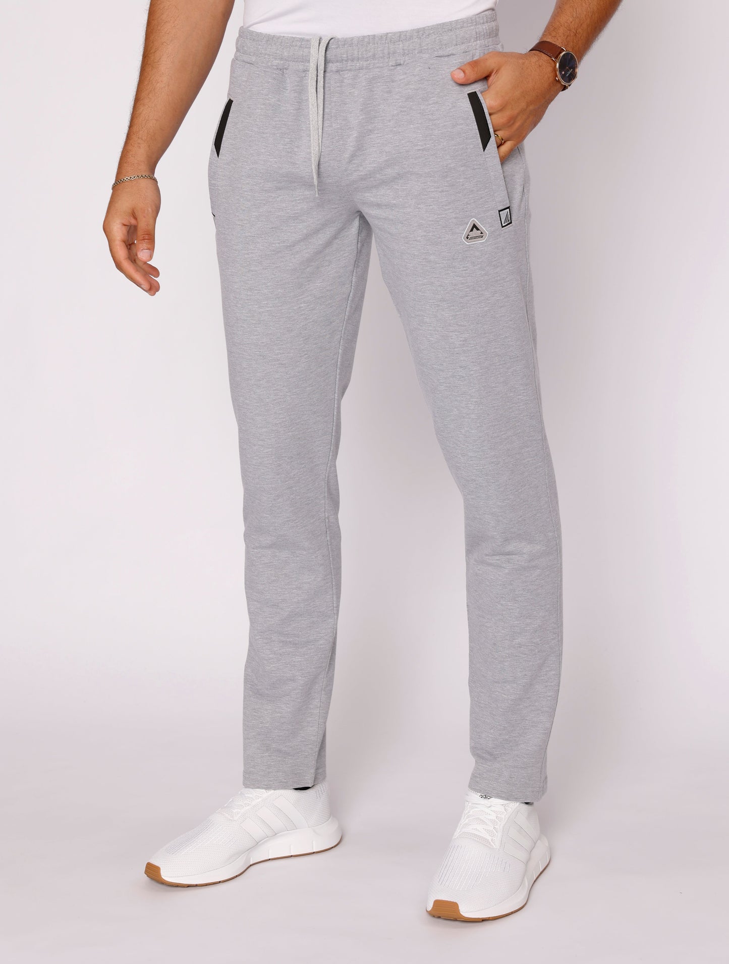 Light gray athletic sweatpants with tapered fit, drawstring waist, small logo