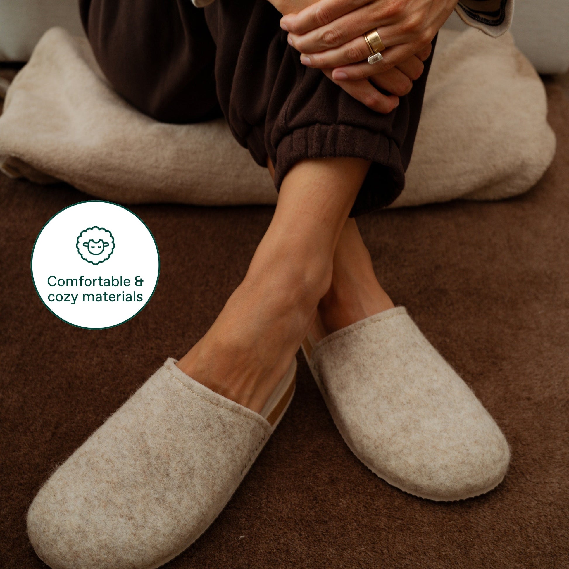 Beige house slippers with plush lining and deep heel cup design