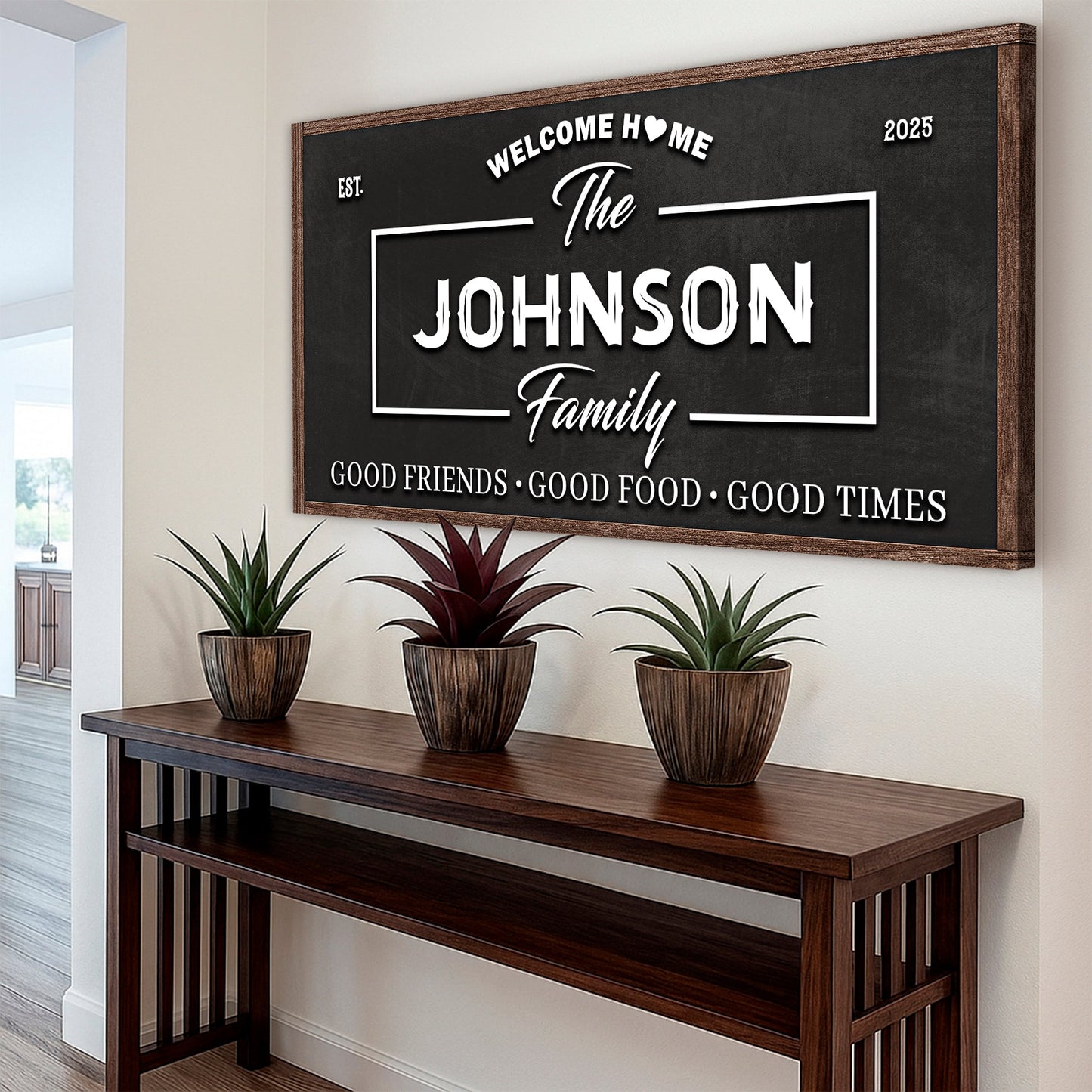 Wall sign with dark background and white “The Johnson Family” text above a long console