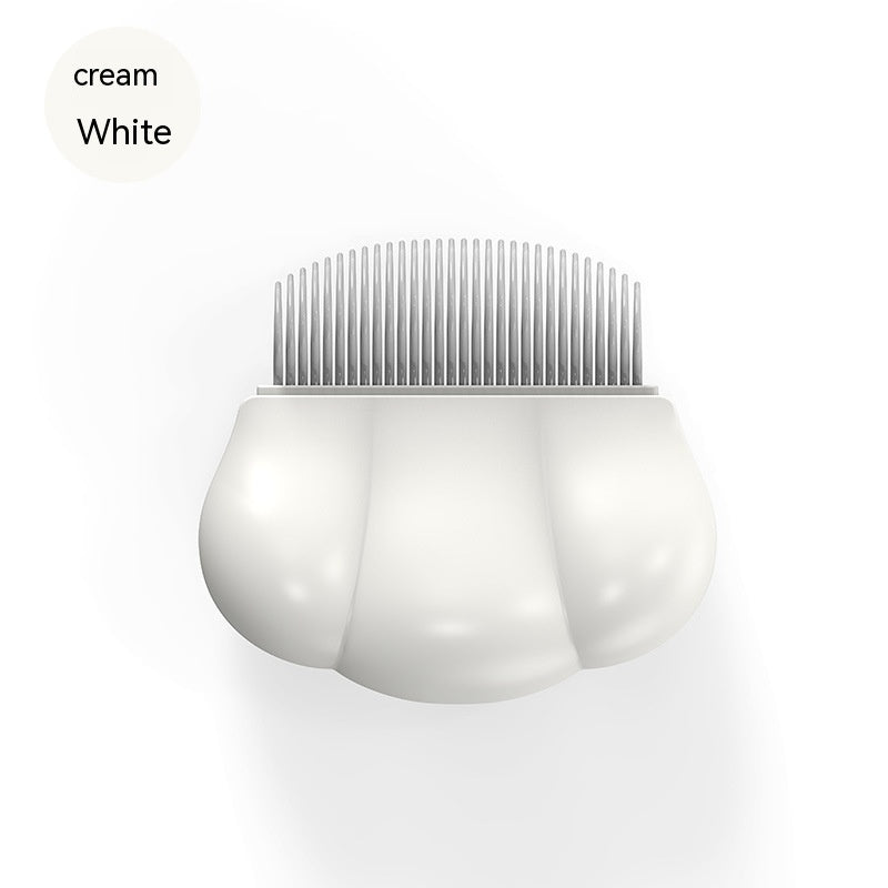 Cream white pet shell grooming comb with fine metal teeth, rounded shell body