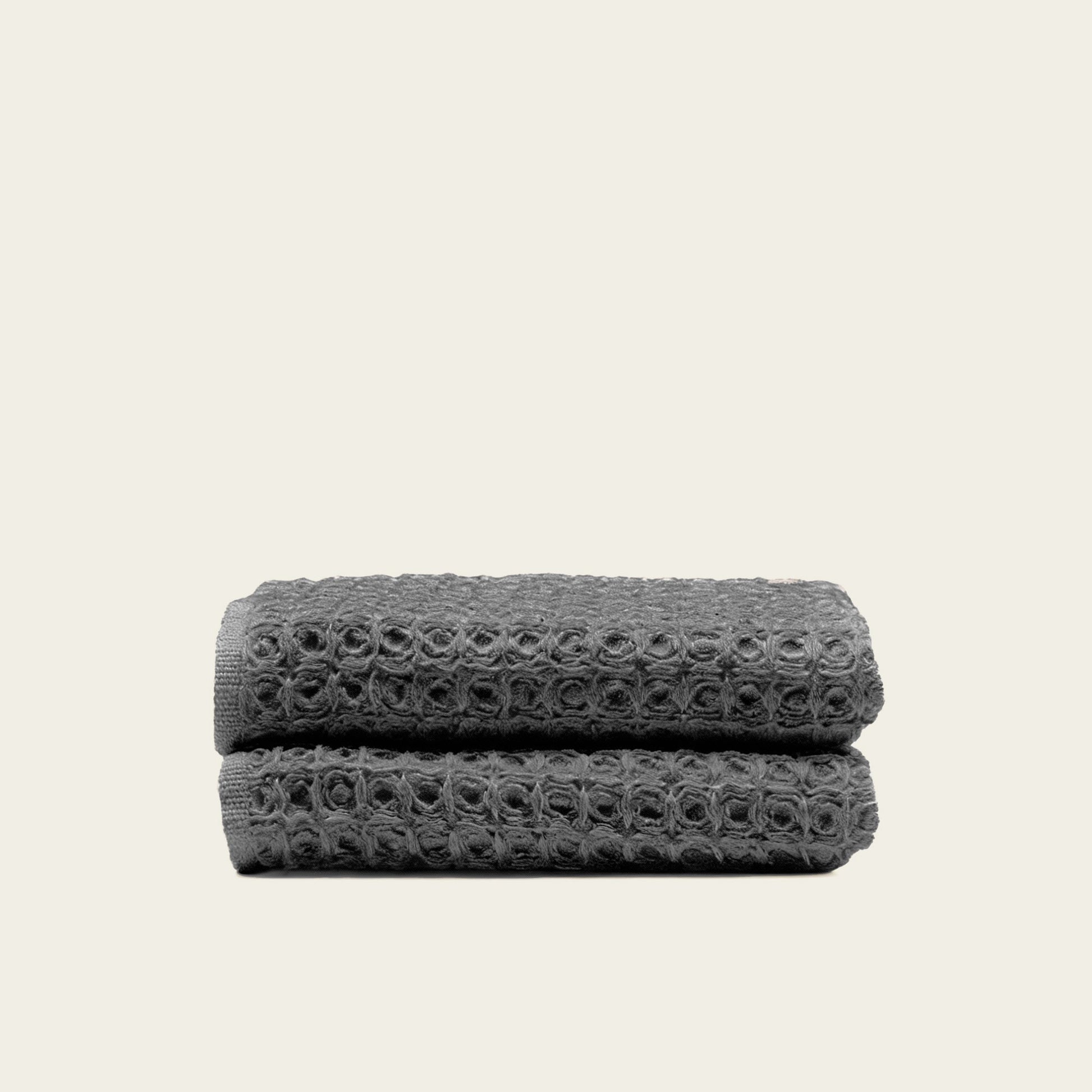 Charcoal waffle bath towel folded, showing woven waffle texture