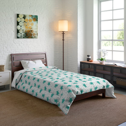 Comforter with teal all-over floral print on white, centered on bed surface