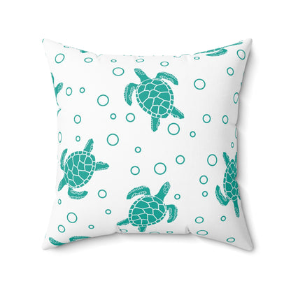 Square decorative pillow with teal sea turtles and outlined teal rings on white background