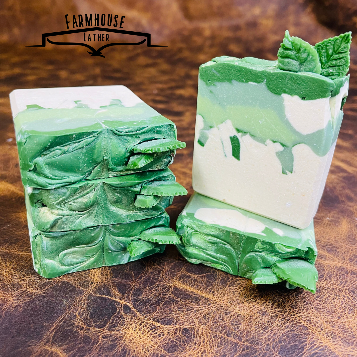 Spearmint soap bars, green and white swirled pieces stacked on a table.