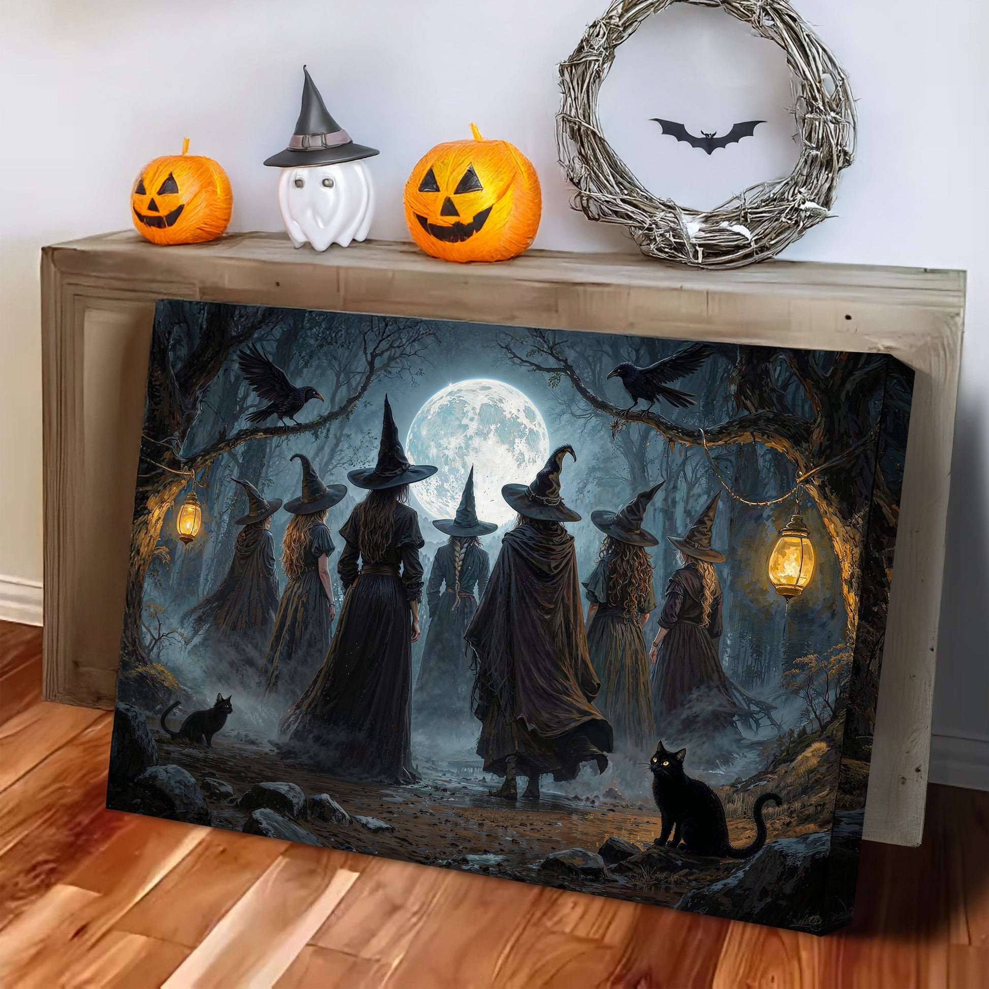Halloween witch wall art canvas leaning on a wooden surface, showing silhouetted witches.