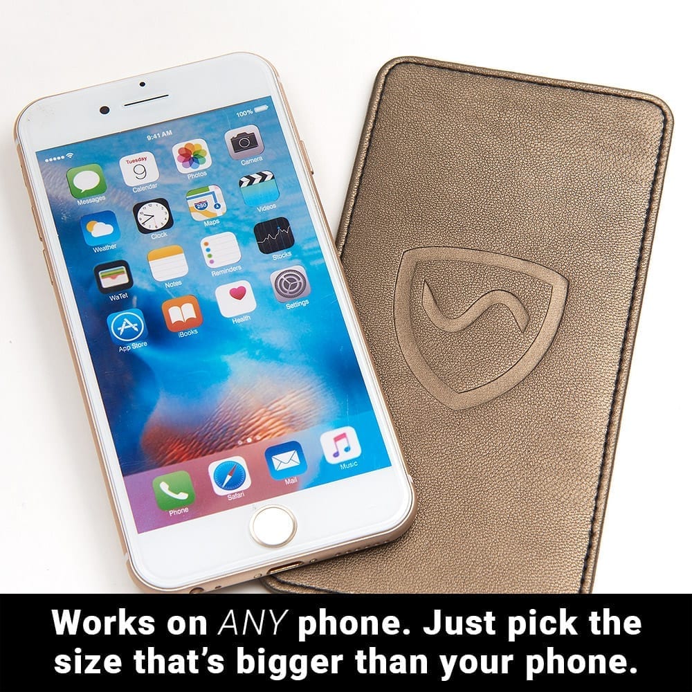 Beige phone shield wallet with stitched border and shielding emblem beside phone