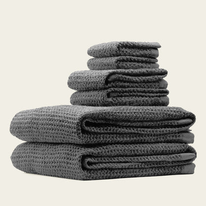 Charcoal waffle towels stacked with folded edges and textured cotton surface